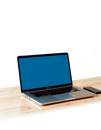 Laptop with blue screen on a wooden desk isolated on white backgroundの写真素材