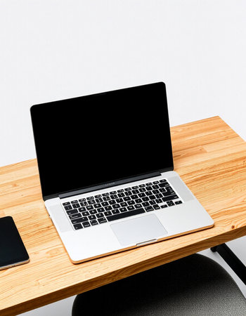 Laptop with blank screen on wooden desk isolated on white background.