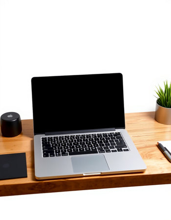 Laptop computer with blank screen on wooden table with coffee cup, smartphone and other items