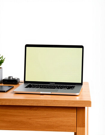 Laptop with blank screen on wooden table isolated on white background.
