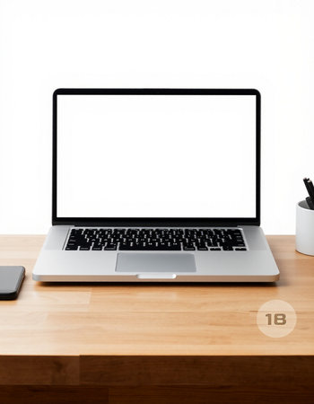 Laptop computer with blank screen on wooden table and white background.