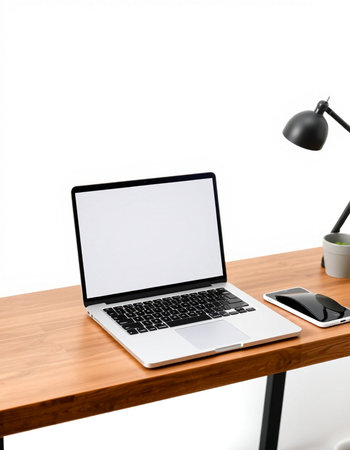 Close up of modern workplace with blank screen laptop, smartphone and coffee cup on wooden table isolated on white backgroundの写真素材