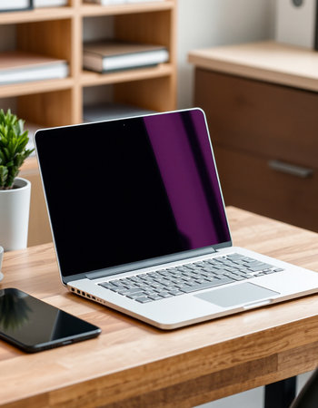 laptop with blank screen on wooden table in office, mockup