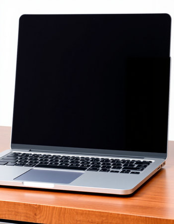 Laptop with blank screen on wood table isolated on white background.