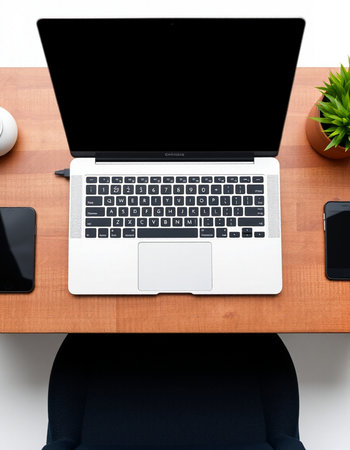 Top view of modern workplace with laptop, smartphone and coffee cup on wooden table