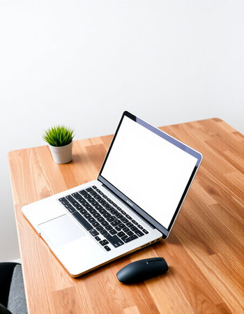 laptop with blank screen on wooden desk and computer mouse on white backgroundの写真素材