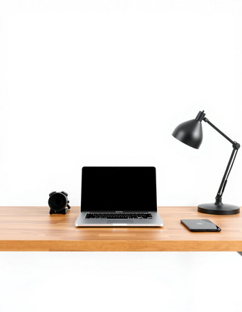 Laptop with blank screen on wood table and lamp on white background