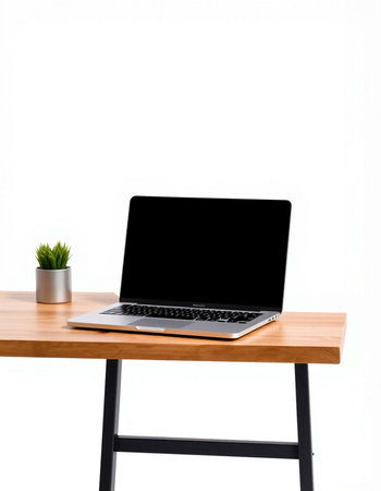 Laptop with blank screen on wooden table isolated on white background.