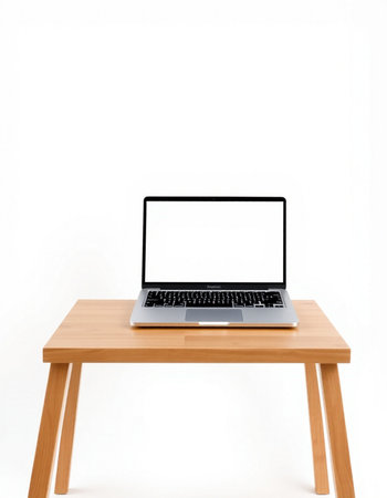 Laptop computer with blank white screen on wooden table isolated on white backgroundの写真素材