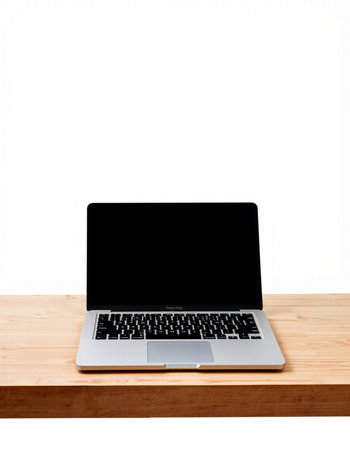 Laptop with blank screen on wooden table isolated on white background.