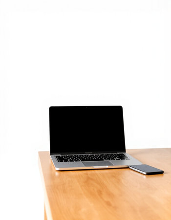 Laptop computer with blank screen on wooden table isolated on white background