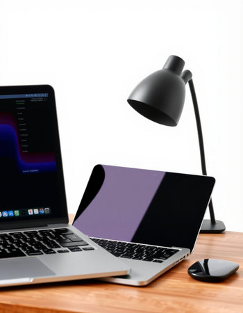 laptop and lamp on wood desk with white background, stock photo