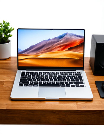 Laptop on wooden desk with dunes and speaker on white background