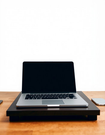 Laptop on a wooden desk with white background and copyspace