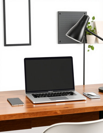 Laptop with blank screen on wooden table in modern office.