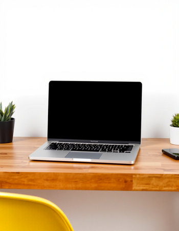 Laptop with blank screen on a wooden desk in a home officeの写真素材