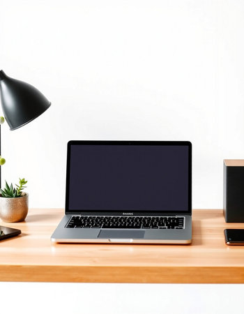 Laptop computer with blank screen on wooden table and white wall background