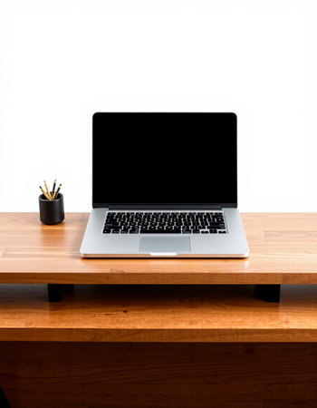 Laptop with blank screen on wooden desk and white wall background.の写真素材