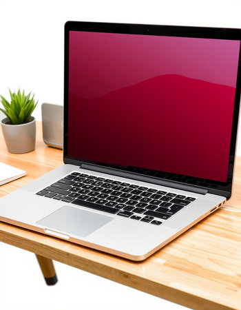 Laptop computer with blank screen on wooden table isolated on white background