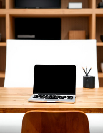 Laptop with blank screen on wooden desk in office. Mock upの写真素材