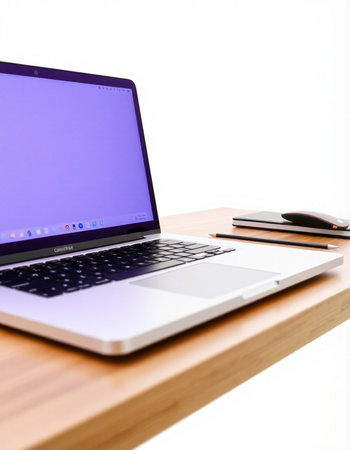 Laptop on wooden desk with keyboard and mouse on white background.の写真素材