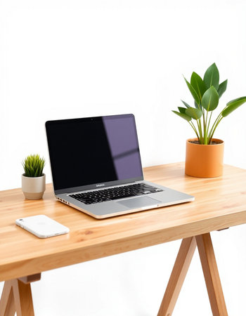 Laptop computer with blank screen on wooden table in office, stock photo