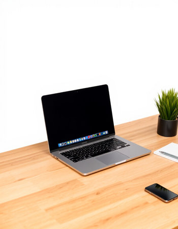 Laptop with blank screen on wood table and white wall background.