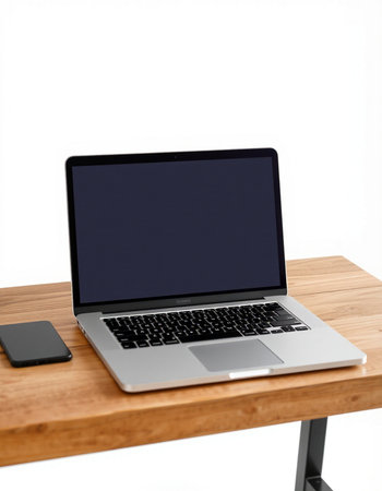Laptop on a wooden table isolated on white background. Work spaceの写真素材