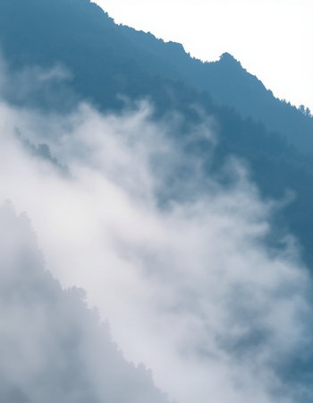 Mountains and clouds in the mist. Beautiful nature landscape background.
