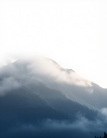 mountains in the mist and clouds on the sky in the morning