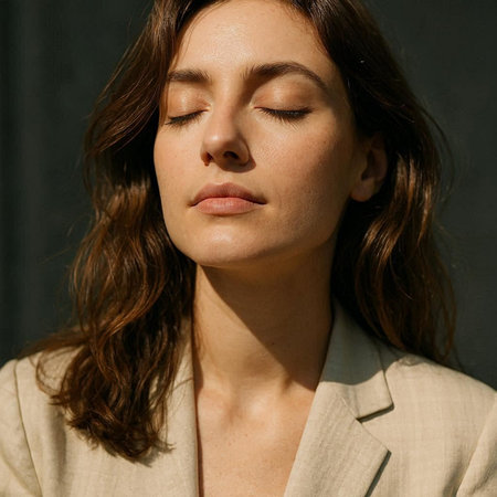 Portrait of a beautiful young brunette woman with closed eyes.