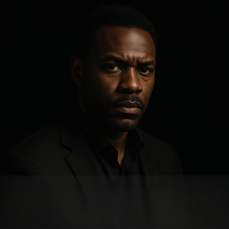 Portrait of a serious african american man on black background