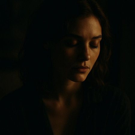 Portrait of a beautiful young woman with long curly hair in a dark room