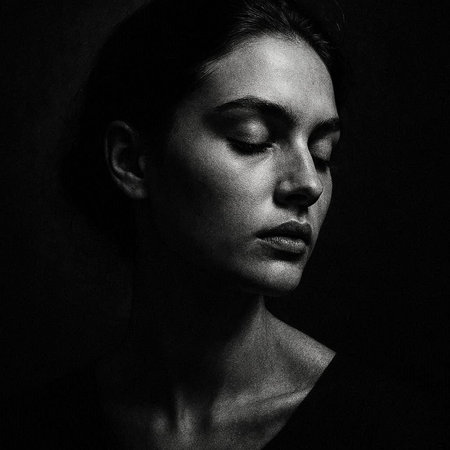 Black and white portrait of a young beautiful woman with closed eyes.
