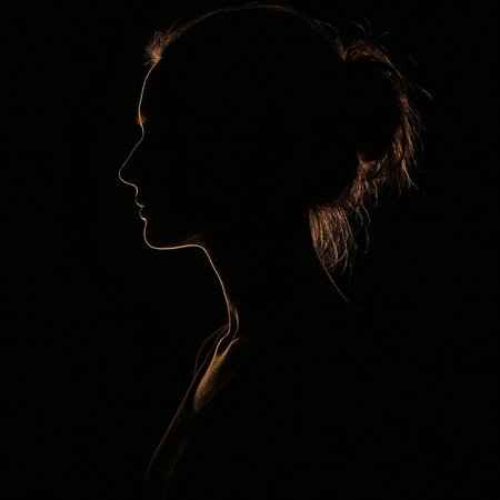 Silhouette of a beautiful young woman on a black background.