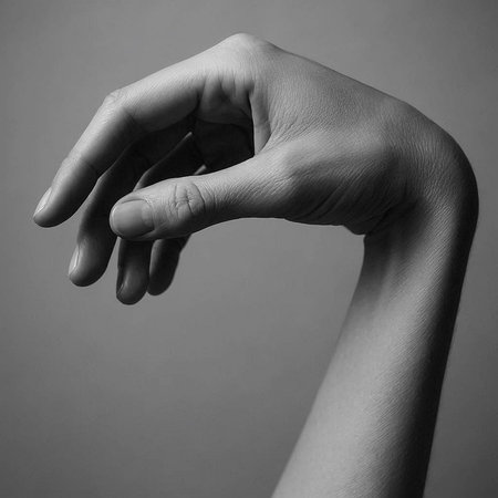 Black and white photo of woman's hand showing sign of stop gesture