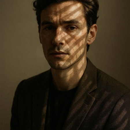 Portrait of a handsome young man in a coat with blinds