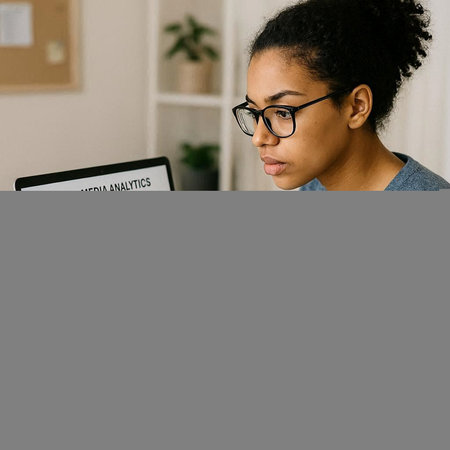 Young african american woman in eyeglasses using digital tablet while working at home