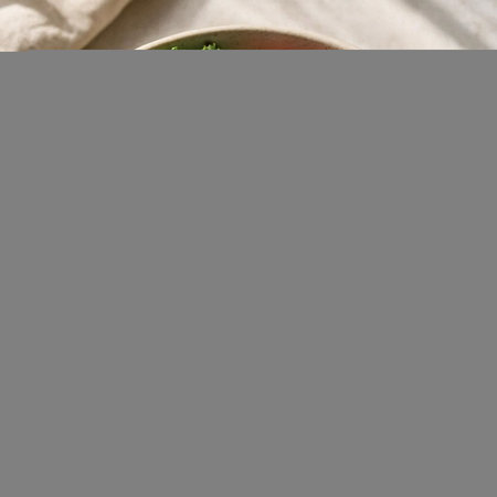 Healthy green salad in a bowl on a light background, top viewの写真素材