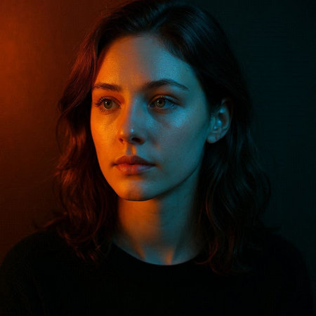 Close-up portrait of a beautiful young woman on a dark background