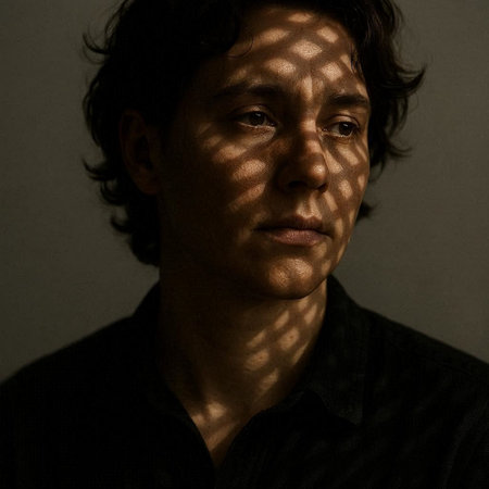 Portrait of a young man with a shadow on his face.