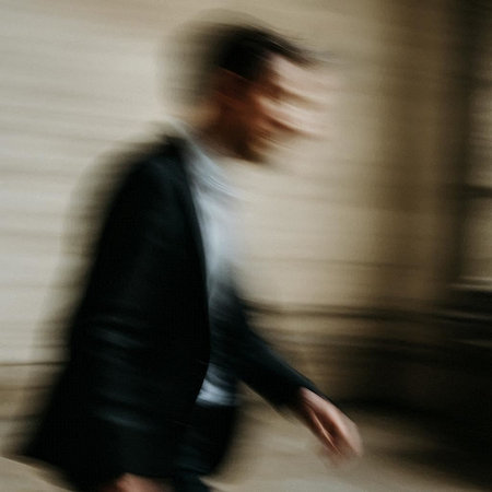 blurred image of a businessman walking in the street, motion blur