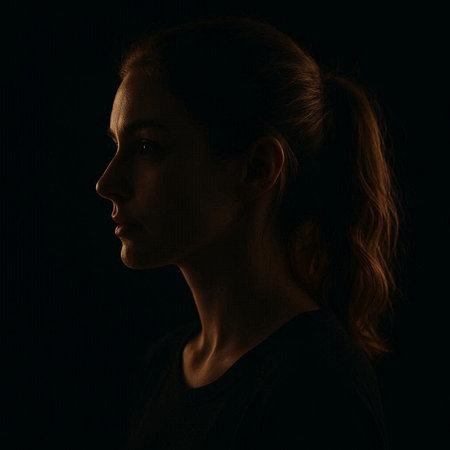 Portrait of a beautiful girl in a black dress on a dark backgroundの写真素材