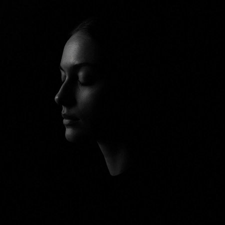 Silhouette of a woman with closed eyes on a black background