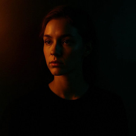 Portrait of a young woman in a black T-shirt on a dark background