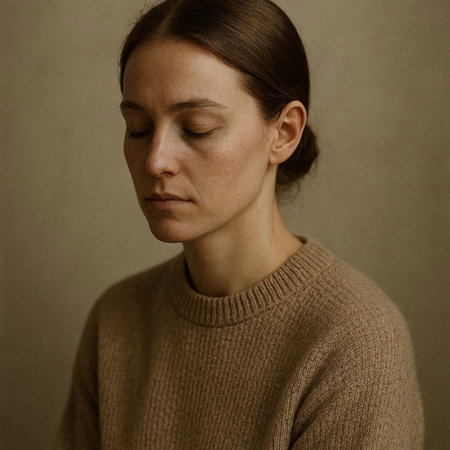Portrait of a young woman in a brown sweater on a gray background