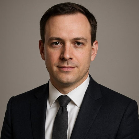Portrait of a handsome man in a suit and tie on a gray background
