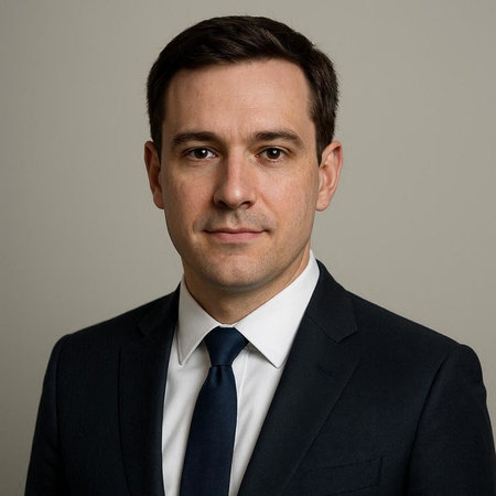 Portrait of a handsome businessman in suit and tie against grey background