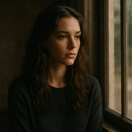 Portrait of a beautiful young woman in a black sweater near the window