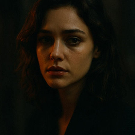 Portrait of a beautiful woman with long brown hair in a dark room